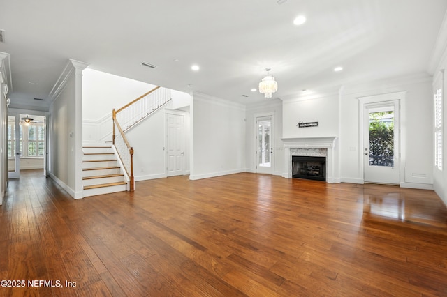 318 Sophia Ter, Saint Augustine, FL 32095 - unfurnished living room with crown molding, stairway, hardwood / wood-style floors, recessed lighting, and a premium fireplace
