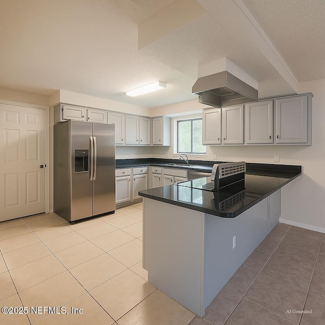 10244 Pine Breeze Rd W, Jacksonville, FL 32257 - kitchen featuring stainless steel fridge, a peninsula, dark countertops, light tile patterned floors, and a sink