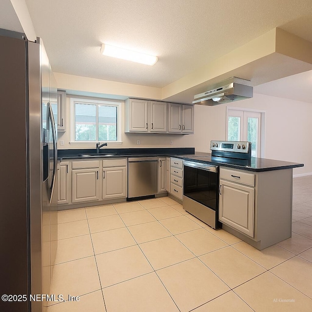 10244 Pine Breeze Rd W, Jacksonville, FL 32257 - kitchen with stainless steel appliances, under cabinet range hood, and dark countertops