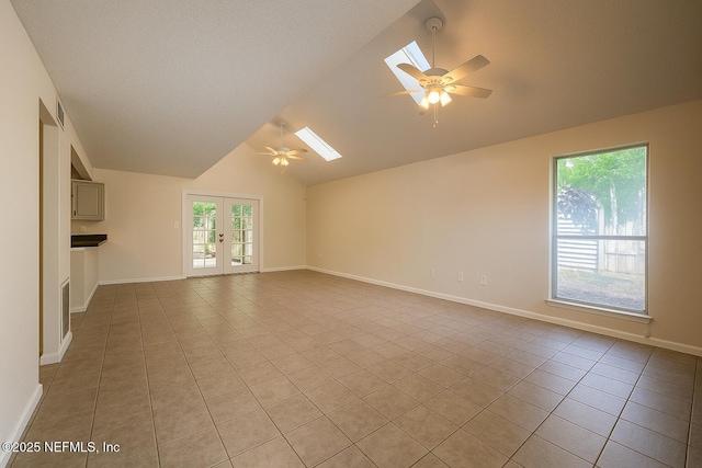 10244 Pine Breeze Rd W, Jacksonville, FL 32257 - unfurnished living room featuring a ceiling fan, a skylight, vaulted ceiling, and light tile patterned flooring