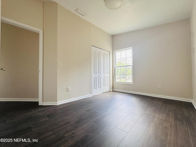 10244 Pine Breeze Rd W, Jacksonville, FL 32257 - unfurnished bedroom with dark wood-style floors, baseboards, and a closet