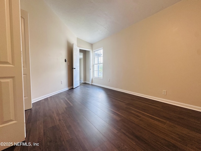 10244 Pine Breeze Rd W, Jacksonville, FL 32257 - spare room with dark wood finished floors, baseboards, and vaulted ceiling