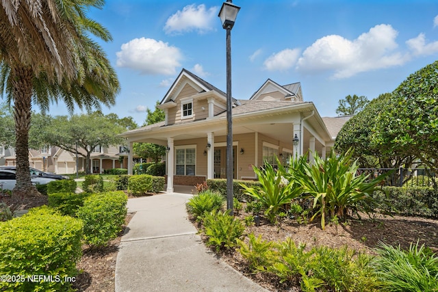 11000 Castlemain Cir E, Jacksonville, FL 32256 - view of front facade featuring a porch and roof with shingles