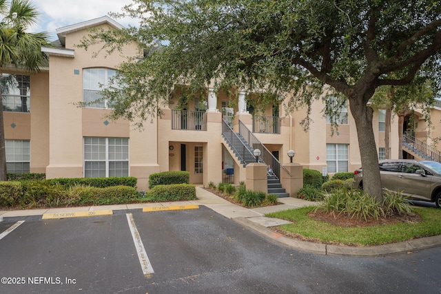 204 Augusta Cir, Saint Augustine, FL 32086 - view of building exterior with stairs and uncovered parking