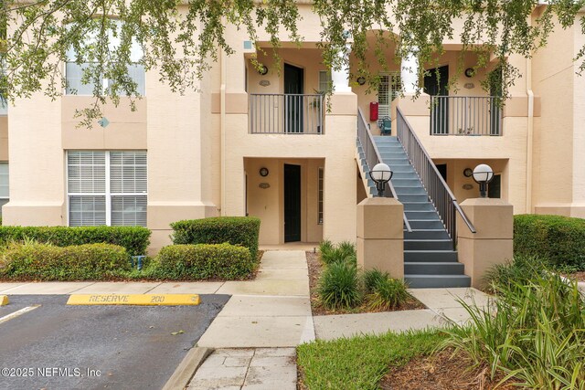 204 Augusta Cir, Saint Augustine, FL 32086 - view of building exterior with stairway and uncovered parking