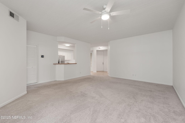 204 Augusta Cir, Saint Augustine, FL 32086 - unfurnished living room featuring carpet flooring, a ceiling fan, baseboards, and a textured ceiling