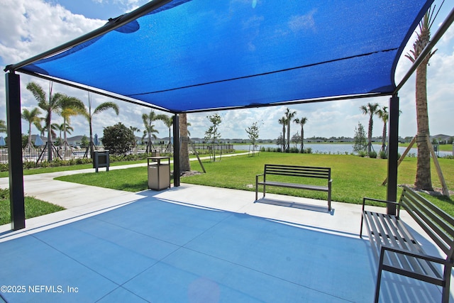 view of community featuring a water view and a yard