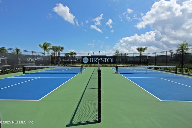 view of tennis court with fence and community basketball court