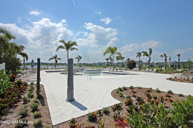 surrounding community with a swimming pool and a patio area