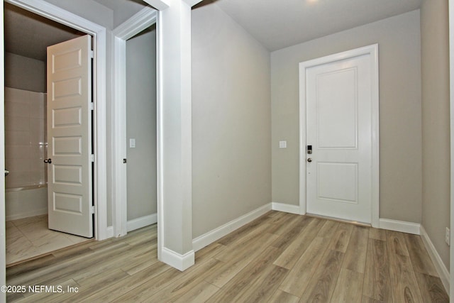 entryway featuring light wood-style floors and baseboards
