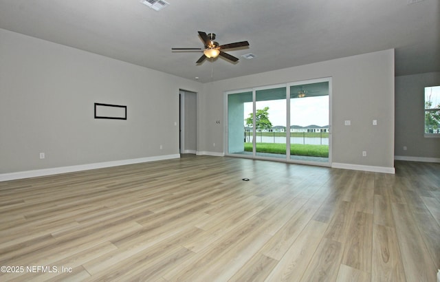 empty room featuring ceiling fan, baseboards, and light wood-style flooring