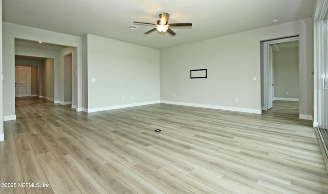 empty room featuring a ceiling fan, light wood-style flooring, and baseboards