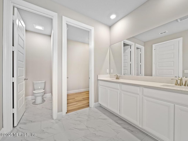 full bathroom featuring marble look tiles, toilet, baseboards, double vanity, and recessed lighting