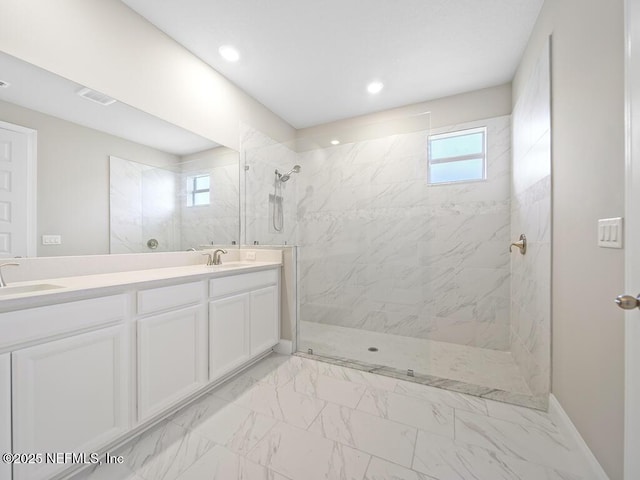 full bath featuring a walk in shower, double vanity, marble finish flooring, recessed lighting, and baseboards