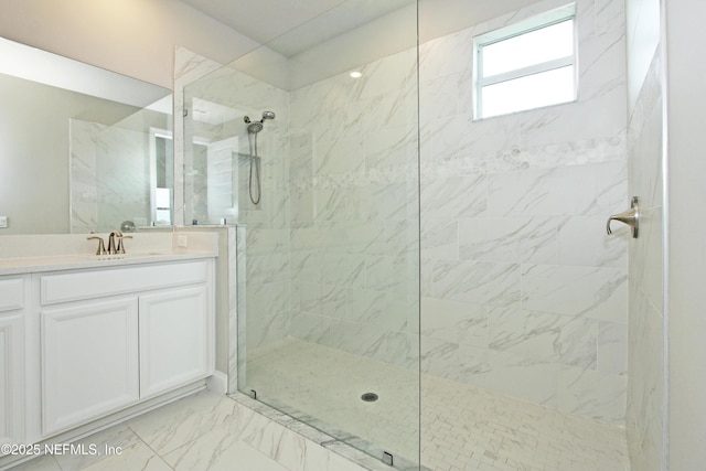 full bath with walk in shower, vanity, and marble look tiles