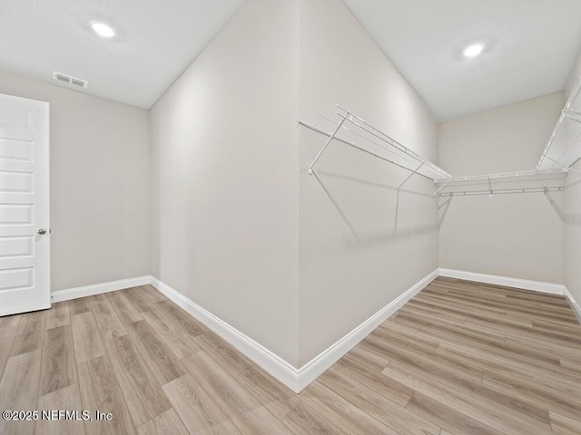 walk in closet featuring wood finished floors