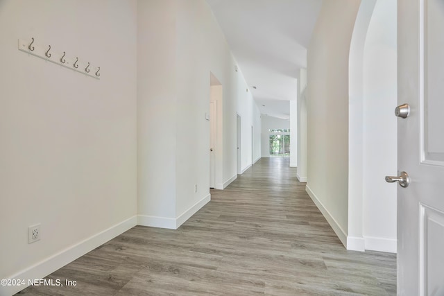 hall featuring baseboards and wood finished floors