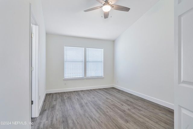 unfurnished room featuring wood finished floors, a ceiling fan, and baseboards