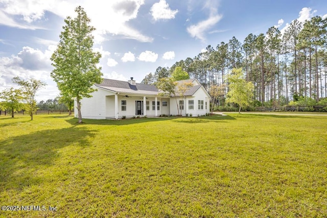 27359 Geiger Rd, Hilliard, FL 32046 - back of property with a ceiling fan and a chimney