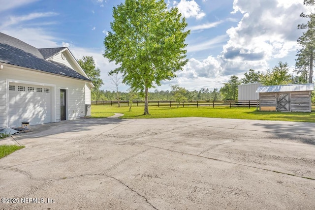 27359 Geiger Rd, Hilliard, FL 32046 - view of patio with driveway, an outdoor structure, and a garage