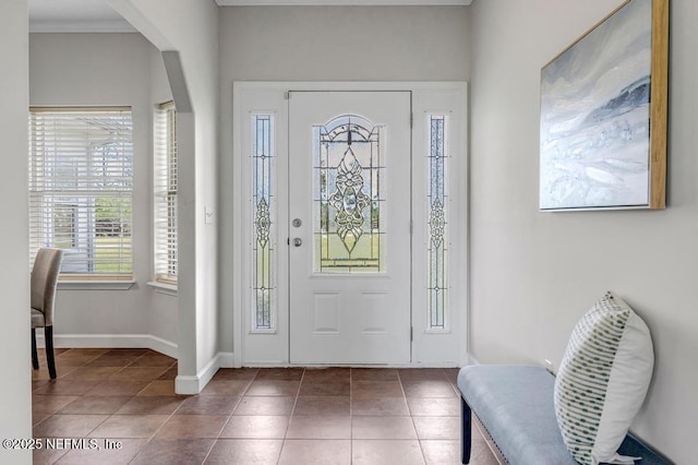 27359 Geiger Rd, Hilliard, FL 32046 - entrance foyer featuring tile patterned floors, baseboards, and arched walkways