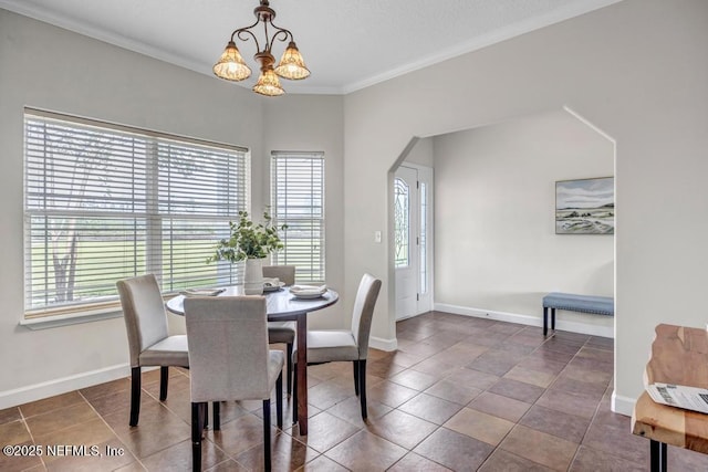 27359 Geiger Rd, Hilliard, FL 32046 - dining area featuring plenty of natural light, a chandelier, crown molding, baseboards, and arched walkways