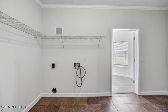 27359 Geiger Rd, Hilliard, FL 32046 - laundry room with washer hookup, baseboards, hookup for an electric dryer, ornamental molding, and dark tile patterned flooring