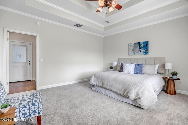 27359 Geiger Rd, Hilliard, FL 32046 - bedroom with carpet flooring, ornamental molding, a tray ceiling, baseboards, and ceiling fan