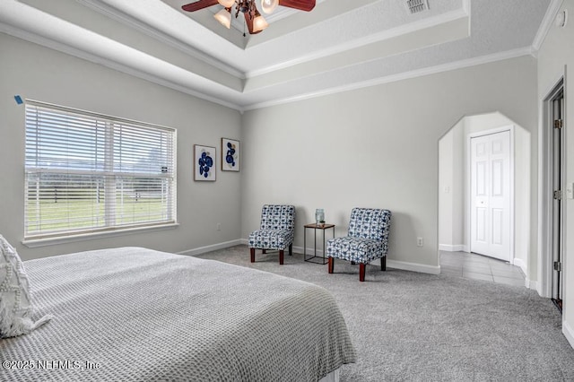 27359 Geiger Rd, Hilliard, FL 32046 - carpeted bedroom featuring a raised ceiling, ornamental molding, arched walkways, baseboards, and a ceiling fan