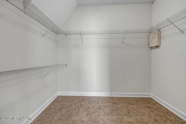 27359 Geiger Rd, Hilliard, FL 32046 - walk in closet featuring tile patterned flooring and lofted ceiling