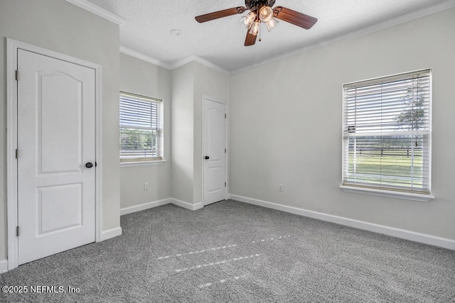 27359 Geiger Rd, Hilliard, FL 32046 - unfurnished bedroom featuring carpet floors, baseboards, ornamental molding, a textured ceiling, and ceiling fan