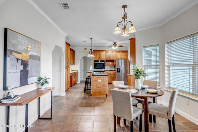 27359 Geiger Rd, Hilliard, FL 32046 - dining area with ornamental molding, ceiling fan, a chandelier, light tile patterned floors, and baseboards