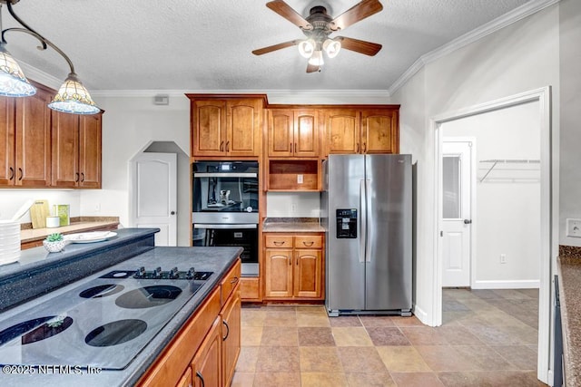 27359 Geiger Rd, Hilliard, FL 32046 - kitchen with appliances with stainless steel finishes, brown cabinets, ornamental molding, ceiling fan, and a textured ceiling