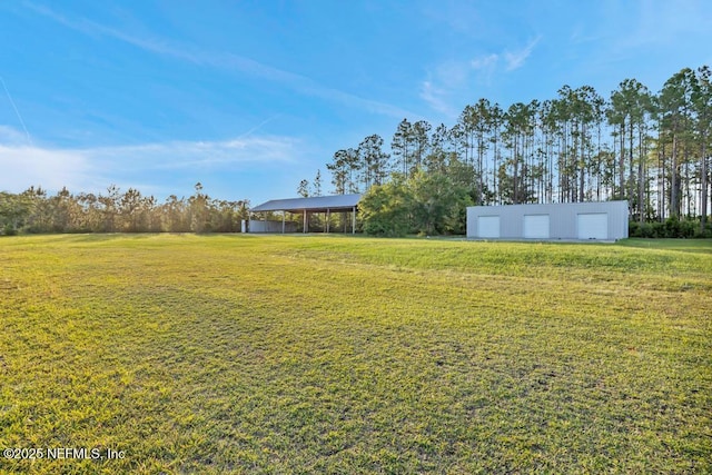 27359 Geiger Rd, Hilliard, FL 32046 - view of grassy yard featuring an outdoor structure and a garage