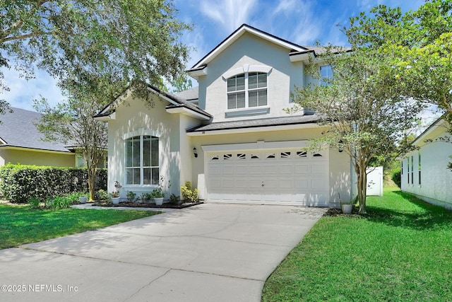 767 Mosswood Chase St, Orange Park, FL 32065 - traditional-style home featuring stucco siding, an attached garage, a front yard, driveway, and a shingled roof