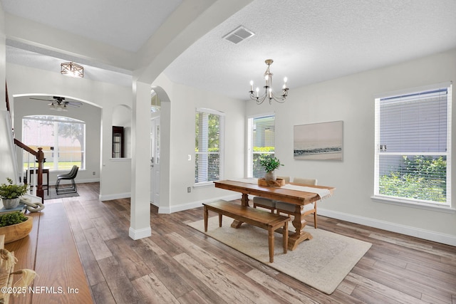 767 Mosswood Chase St, Orange Park, FL 32065 - dining space featuring a chandelier, arched walkways, wood finished floors, baseboards, and ceiling fan