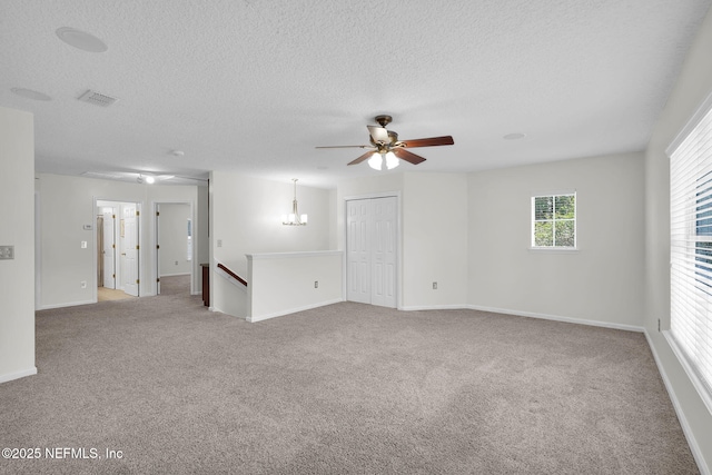 767 Mosswood Chase St, Orange Park, FL 32065 - spare room featuring ceiling fan, carpet floors, a textured ceiling, baseboards, and a chandelier