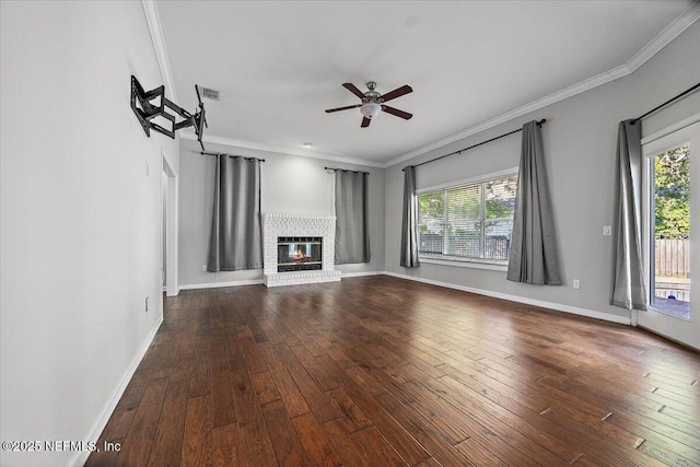 unfurnished living room featuring healthy amount of natural light, ceiling fan, dark wood-style floors, crown molding, and baseboards