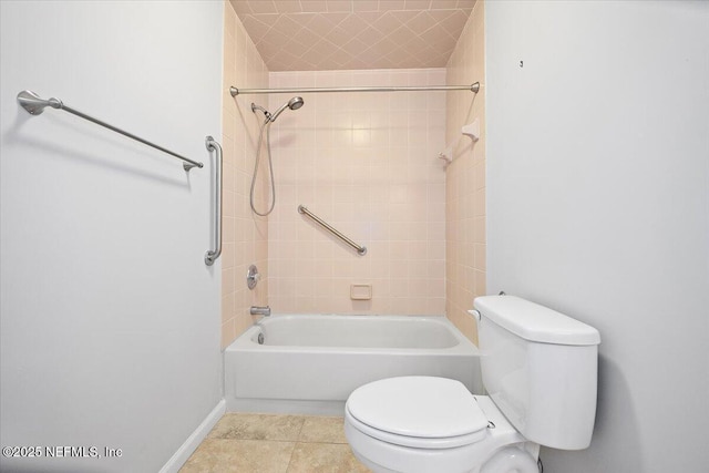 bathroom with toilet, baseboards, washtub / shower combination, and tile patterned flooring