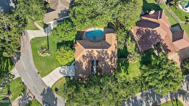 aerial view of property and surrounding area with a pool