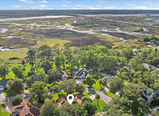 aerial view of property and surrounding area featuring nearby suburban area