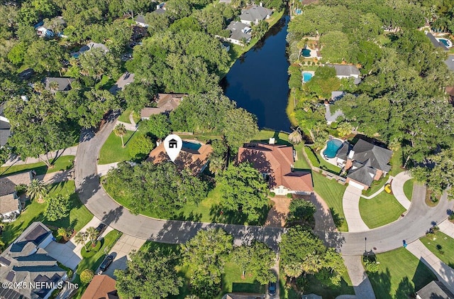 aerial view of property and surrounding area with a large body of water and nearby suburban area