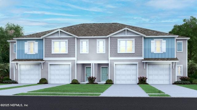 multi unit property with an attached garage, driveway, board and batten siding, and a front lawn