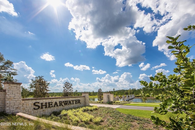 community sign featuring a water view