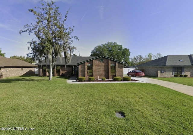 2396 Stonebridge Dr, Orange Park, FL 32065 - view of front of home featuring concrete driveway, brick siding, and a front lawn