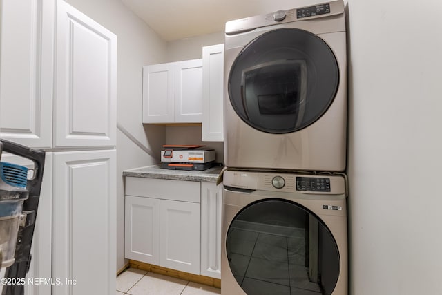 806 Falkirk Ct, Orange Park, FL 32073 - laundry area with cabinet space, stacked washing machine and dryer, and light tile patterned floors