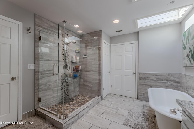 806 Falkirk Ct, Orange Park, FL 32073 - full bathroom featuring a skylight, a stall shower, recessed lighting, and a freestanding tub