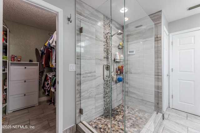 806 Falkirk Ct, Orange Park, FL 32073 - bathroom featuring a stall shower, a spacious closet, and baseboards