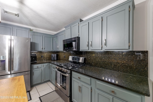 806 Falkirk Ct, Orange Park, FL 32073 - kitchen with stainless steel appliances, light tile patterned floors, dark stone counters, tasteful backsplash, and gray cabinets