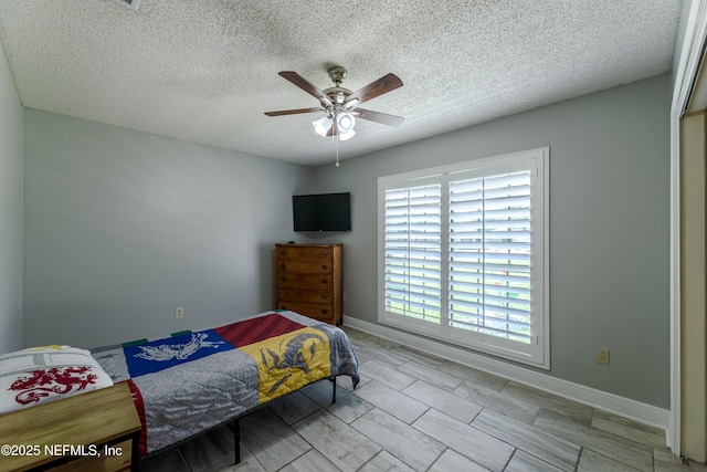 806 Falkirk Ct, Orange Park, FL 32073 - bedroom featuring baseboards, a textured ceiling, and ceiling fan